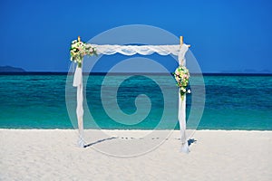 Wedding arch on sandy beach in tropical island