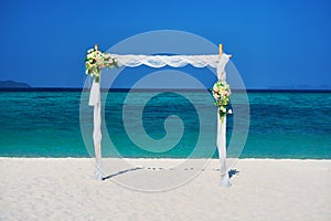Wedding arch on sandy beach in tropical island