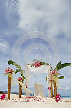 Wedding arch and set up with flowers on tropical beach