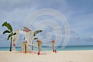 Wedding arch and set up with flowers on tropical beach