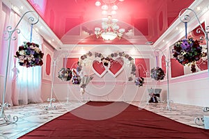 Wedding arch in the shape of two hearts in a hall for ceremonies