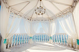 Wedding arch in Tiffany color on the beach.