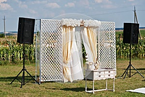 Wedding arch, white carpet with small table on white and golden