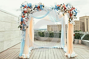 Wedding archway with flowers arranged in city for a wedding ceremony