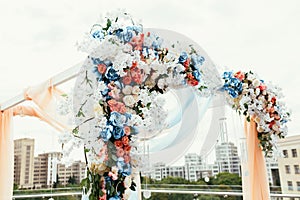 Wedding archway with flowers arranged in city for a wedding ceremony