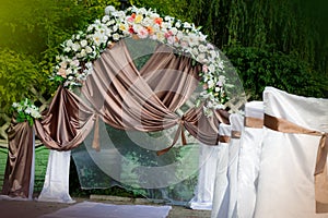 Wedding archway with flowers arranged in park