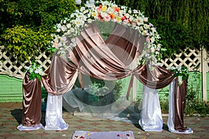 Wedding archway with flowers arranged in park