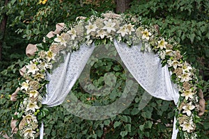 Wedding archway with flowers arranged in park for a wedding ceremony