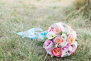 Wedding background. The bride`s bouquet with pink and white flowers on the grass. declaration of love. Wedding card, day details