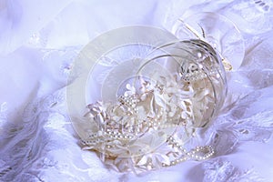 Wedding background with lace, pearls and ribbons.