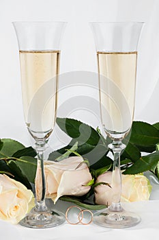 Wedding background with two glasses of champagne, ring and rose