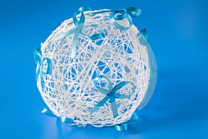 Wedding ball with bows on a blue background of threads