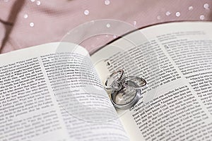Wedding Bands Engagement Ring on Bible New Testament Pages