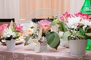 Wedding. Banquet. Flowers. The composition of red, white and green, standing on a table in the area of wedding party.