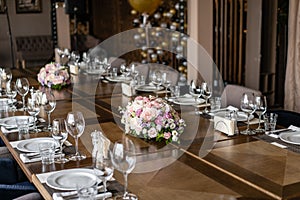 Wedding Banquet or gala dinner. The chairs and table for guests, served with cutlery and crockery.