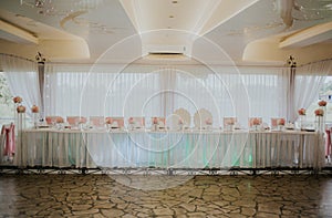 Wedding banquet hall with a beautiful table setting in white and pink colors