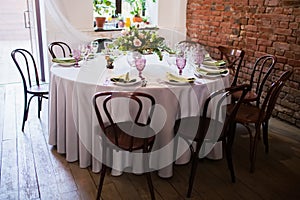 Wedding banquet, loft style, served tables with flowers and lots of greenery