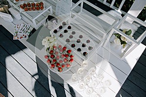 Wedding banquet table setting with wineglasses, snacks and canapes