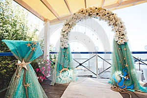 Wedding on the beach. Beautiful wedding arch, decorated with flowers. Sea. The ocean.