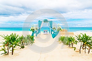 Wedding on the beach . Wedding arch decorated with flowers on tr