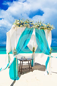 Wedding on the beach . Wedding arch decorated with flowers on tr