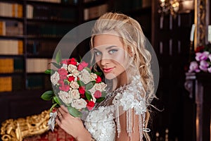 Wedding. Beautiful bride indoors with bouquet of flowers