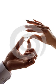 Wedding betrothal of the bride and groom on a white background of hands