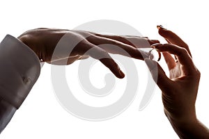 Wedding betrothal of the bride and groom on a white background of hands