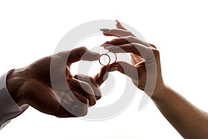 Wedding betrothal of the bride and groom on a white background of hands