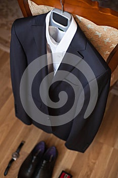 Wedding black jacket hanging on a chair.