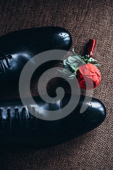 Wedding black shoes of the groom and next to it lies a boutonniere buttonhole