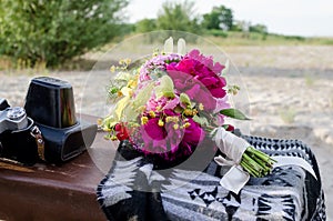 Wedding boho bouquet with pink magenta and yellow flowers.