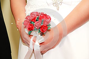 Wedding bouquet of beautiful red flowers and pearls