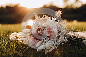 Wedding bouquet boho style on grass. Bride`s flowers