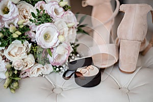 wedding bouquet, boutonniere, rings and shoes on white background