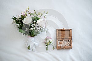 wedding bouquet, boutonniere, rings and shoes on white background