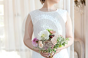 Wedding bouquet of the bride in hand