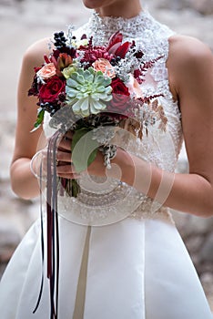 wedding bouquet at bride& x27;s hands