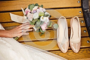 Wedding bouquet and bride shoes