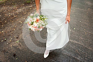 Wedding bouquet and bridesmaid shoes on blue mat