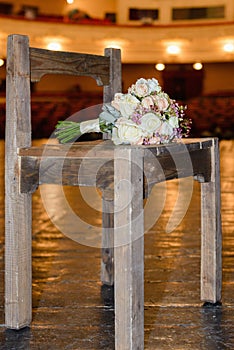 Wedding bouquet on a chair. On the theatrical stage