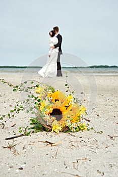 wedding bouquet with a couple on the beach