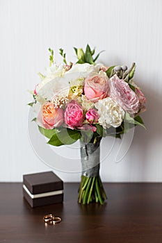 Wedding bouquet and delicate little brown box with wedding rings