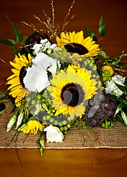 Wedding bouquet detail with sunflowers, lotus pods, and various