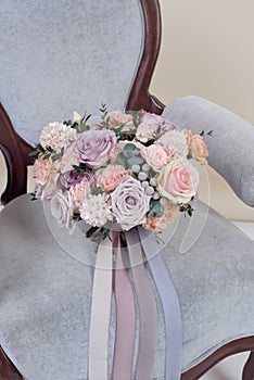 Wedding bouquet of flowers on armchair.
