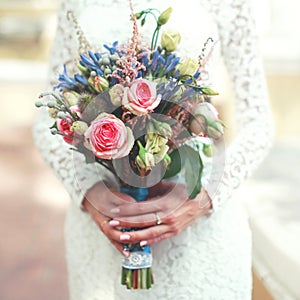 Wedding bouquet of flowers in hands bride