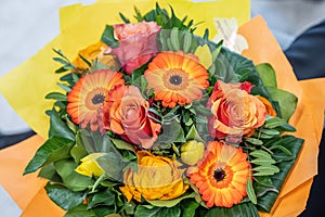 Wedding bouquet of flowers held by bride closeup. orange roses and flowers