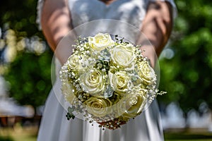 Wedding bouquet of flowers held by bride closeup. yellow roses flower