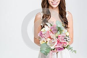 Wedding bouquet of flowers holded by happy young bride
