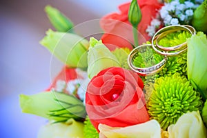 Wedding bouquet and gold rings